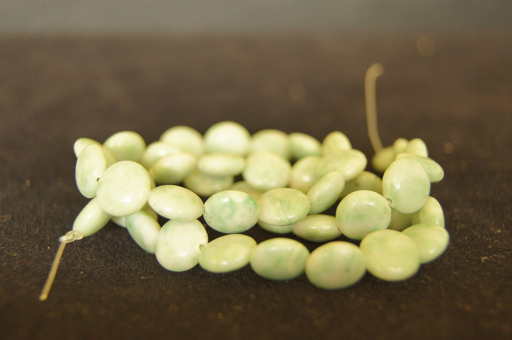 Bead, turquoise (dyed  stabilized), light green, small pebble, Mohs hardness 5 to 6 - 0.7cm oval - $0.50 per pc